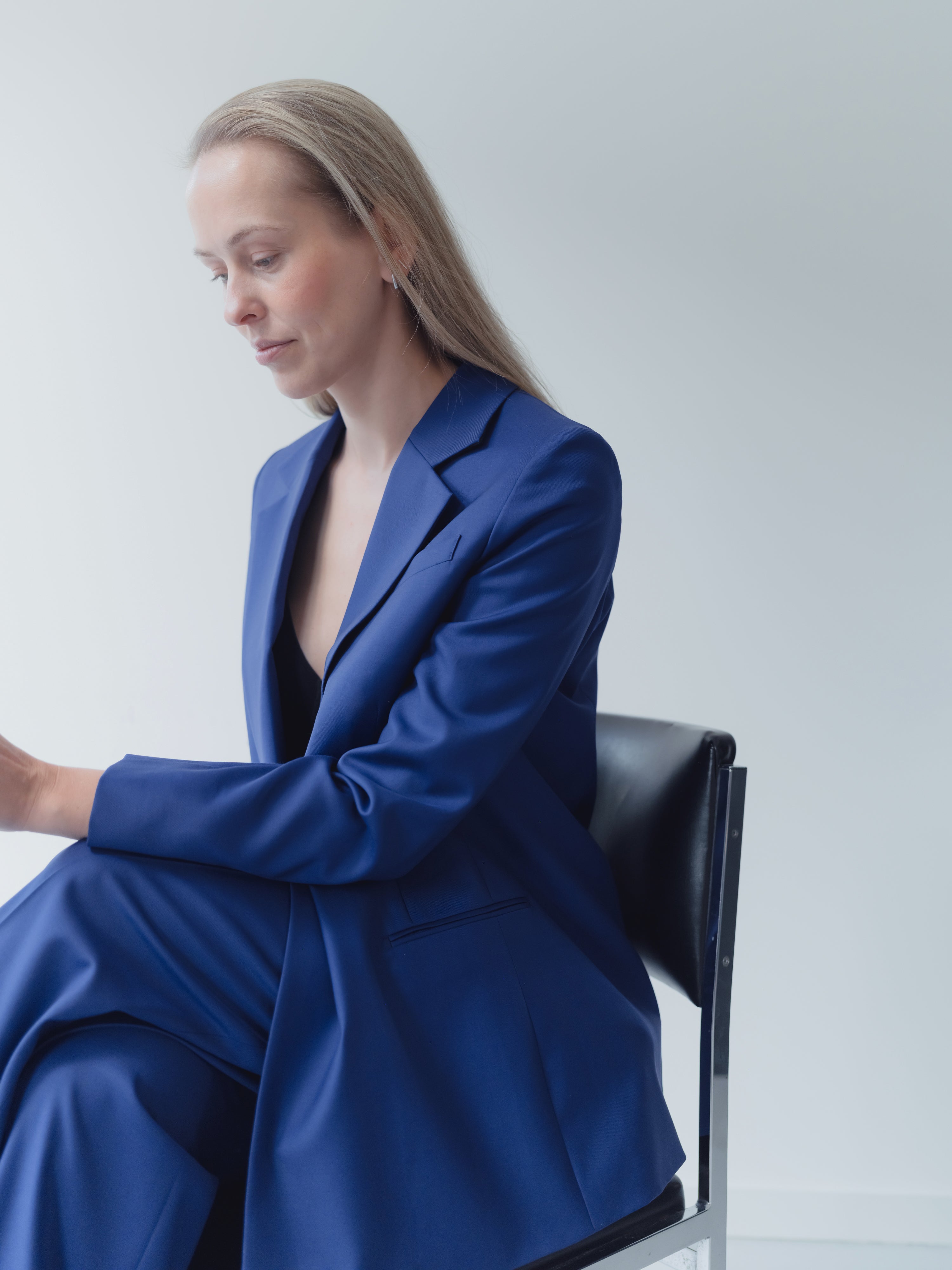 royal blue double-breasted women’s suit in Super 110’s wool with notch lapel and half-canvas construction.